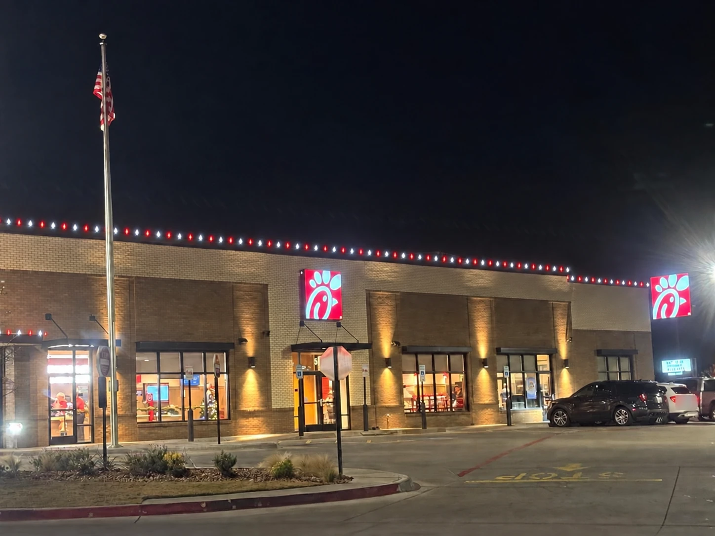 Red and white roofline lighting on a restaurant